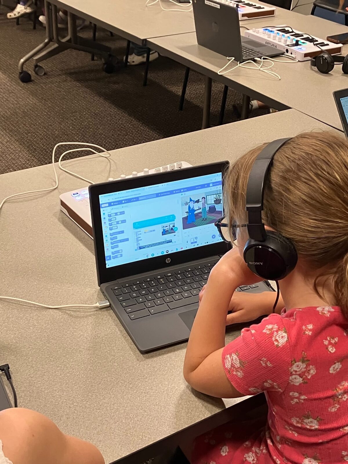 A student writing a Scratch program on a Chromebook
