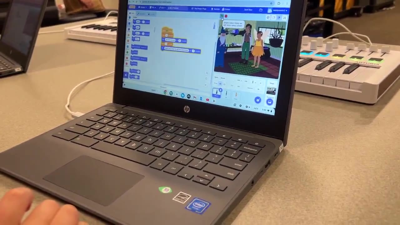 A student codes a Scratch game connected to MIDI keyboards